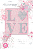 This image shows a romantic anniversary card designed in soothing pastel tones that feel instantly comforting and refined. At its heart, the word "LOVE" is displayed in large, raised letters, each one coated with a soft layer of blush-pink glitter that sparkles just enough to draw attention without overpowering the rest of the artwork. The letters appear plump and tactile, as if you could trace them slowly while thinking of someone special. Behind and around this central word, the background is a velvety, pale pink, fading gently at the edges and reminiscent of the inside of a rose held up to the light. Spilling outwards from the central panel, intricate line drawings of blooms and curling leaves weave across the card, their forms echoing the relaxed elegance of a hand-tied bouquet prepared by a skilled Highams Park florist. The flowers are depicted in soft blush, pearly white, and muted silver-grey, with fine shading that suggests the careful attention of someone used to studying petals and stems in real life. Slender vines and swirling tendrils carry the eye around the composition, giving a sense of movement and quiet celebration, like petals drifting across a path in Vincent Road after a spring breeze. In a refined, flowing script, phrases such as "On Our Anniversary" and "I love you today and always" are set above and below the central motif, their subtle curves harmonising with the floral swirls. The result is a card that feels like a paper bouquet: delicate, romantic, and thoughtfully composed, ideal for expressing enduring devotion on an anniversary shared at home in Highams Park or delivered as part of a surprise gift to a nearby doorstep.